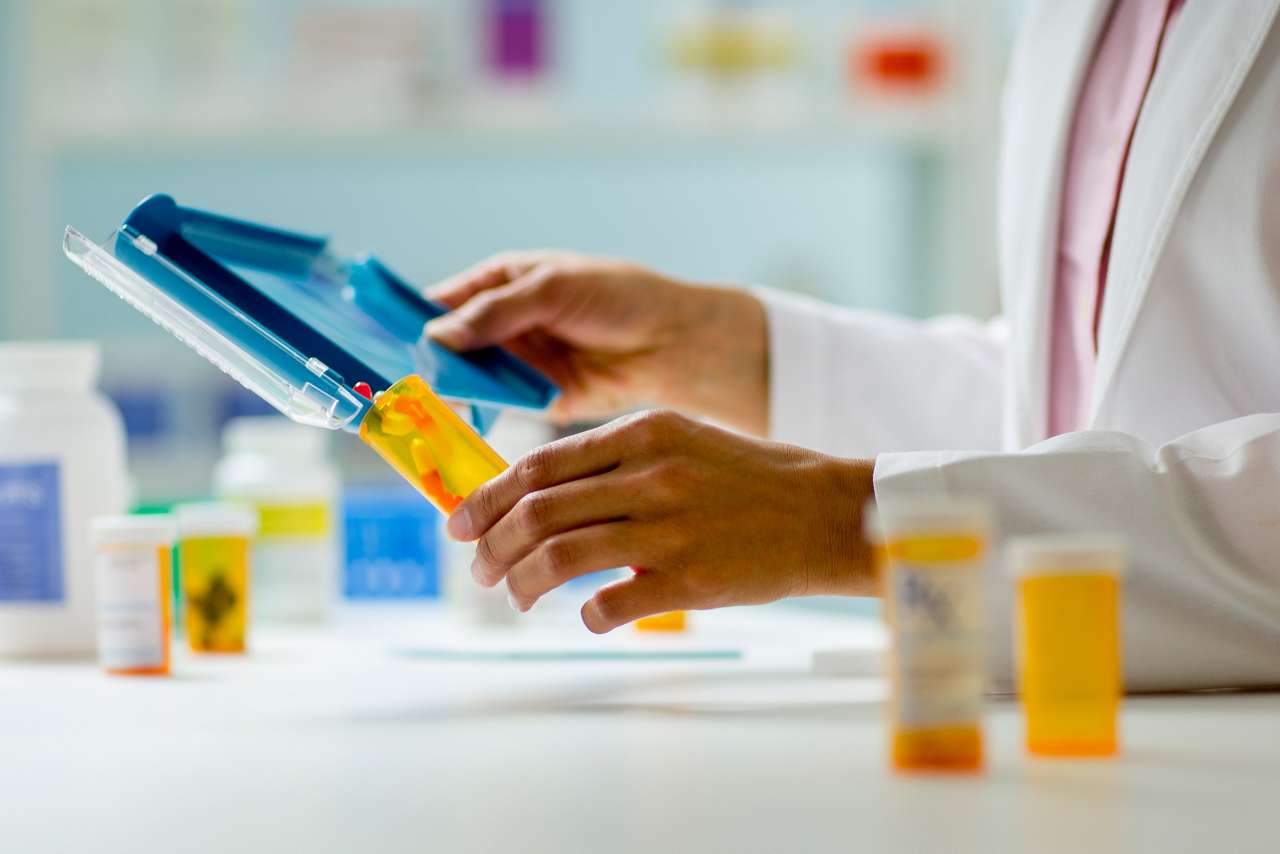 pharmacist fill container with pills