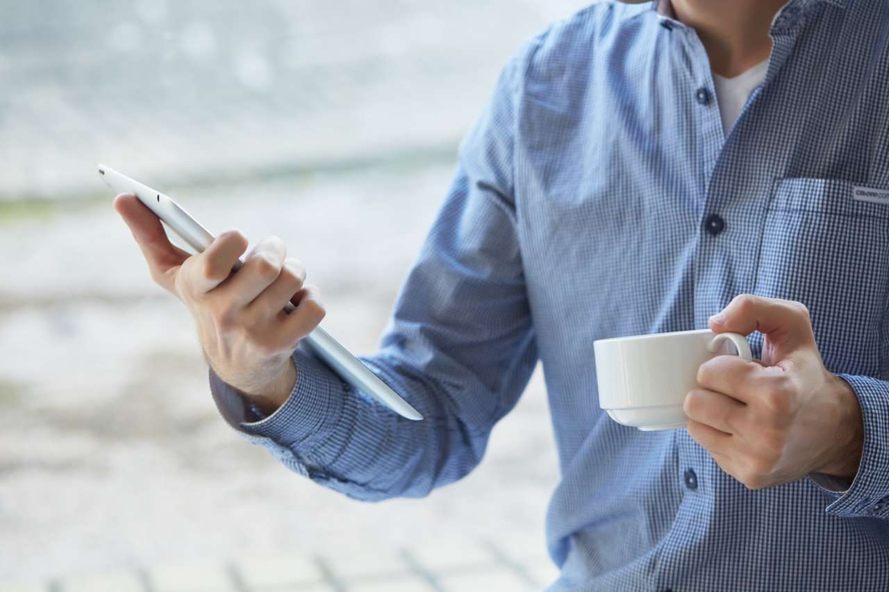 businessman with a cup of coffee and tablet