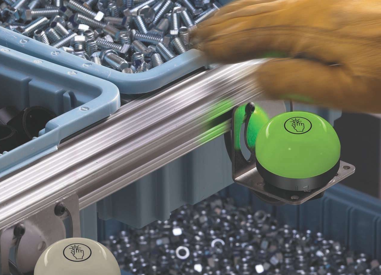 K50 Pick-to-lights on screw bins, blurred gloved hand K70 pick to light device on a mobile assembly station