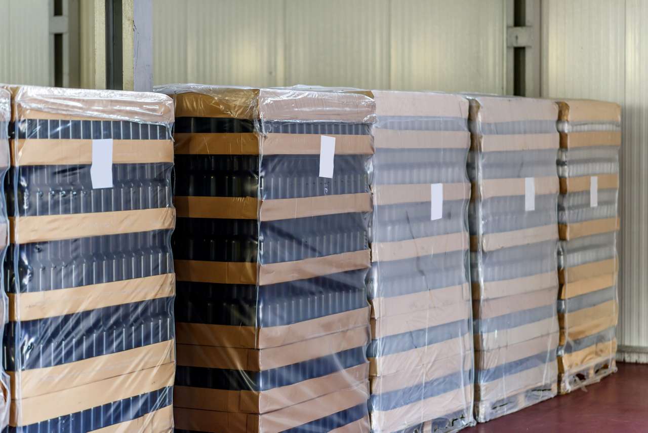 Wine bottles deposit pallets lined up against a wall