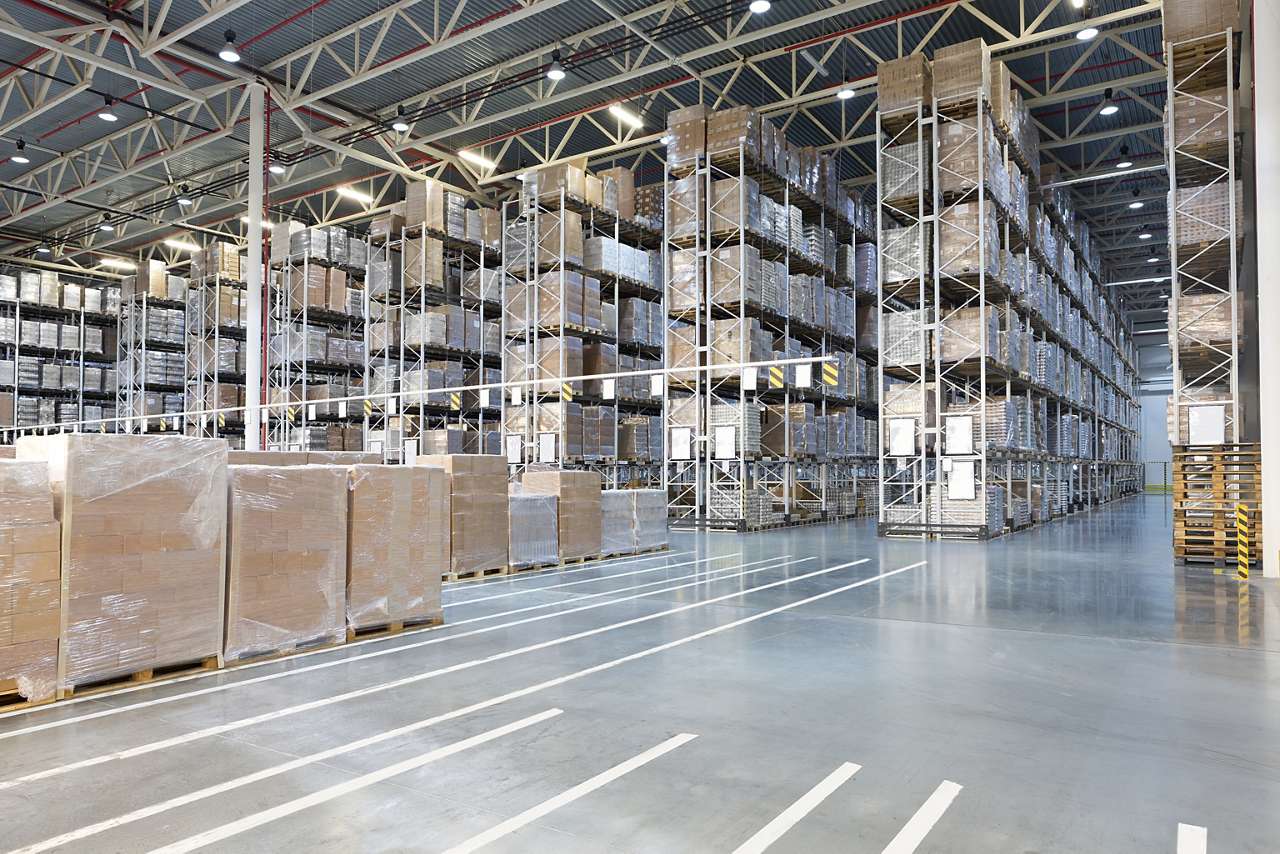 Huge distribution warehouse with high shelves warehouse with shelving and boxes