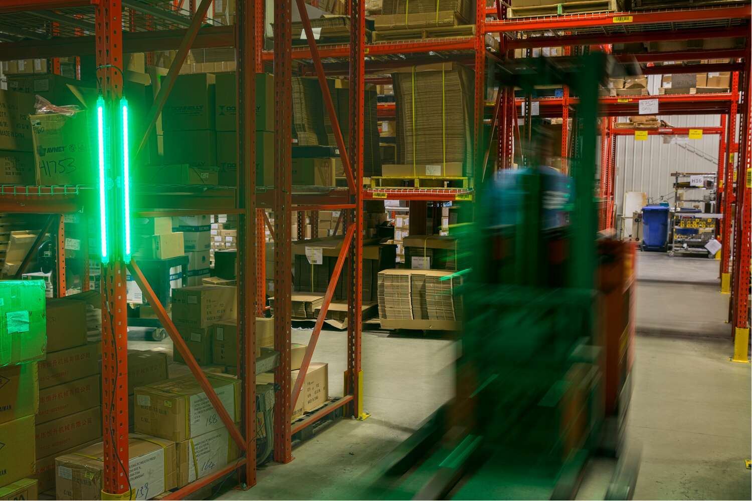 Forklift in warehouse, green indication lights