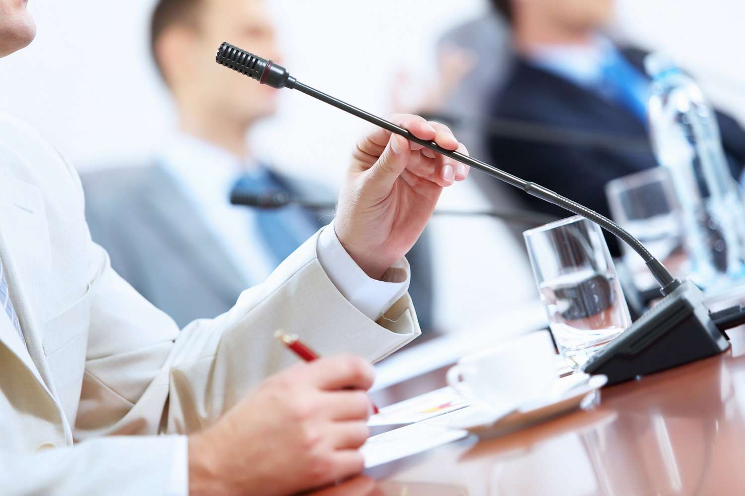 Hands of businessman holding microphone