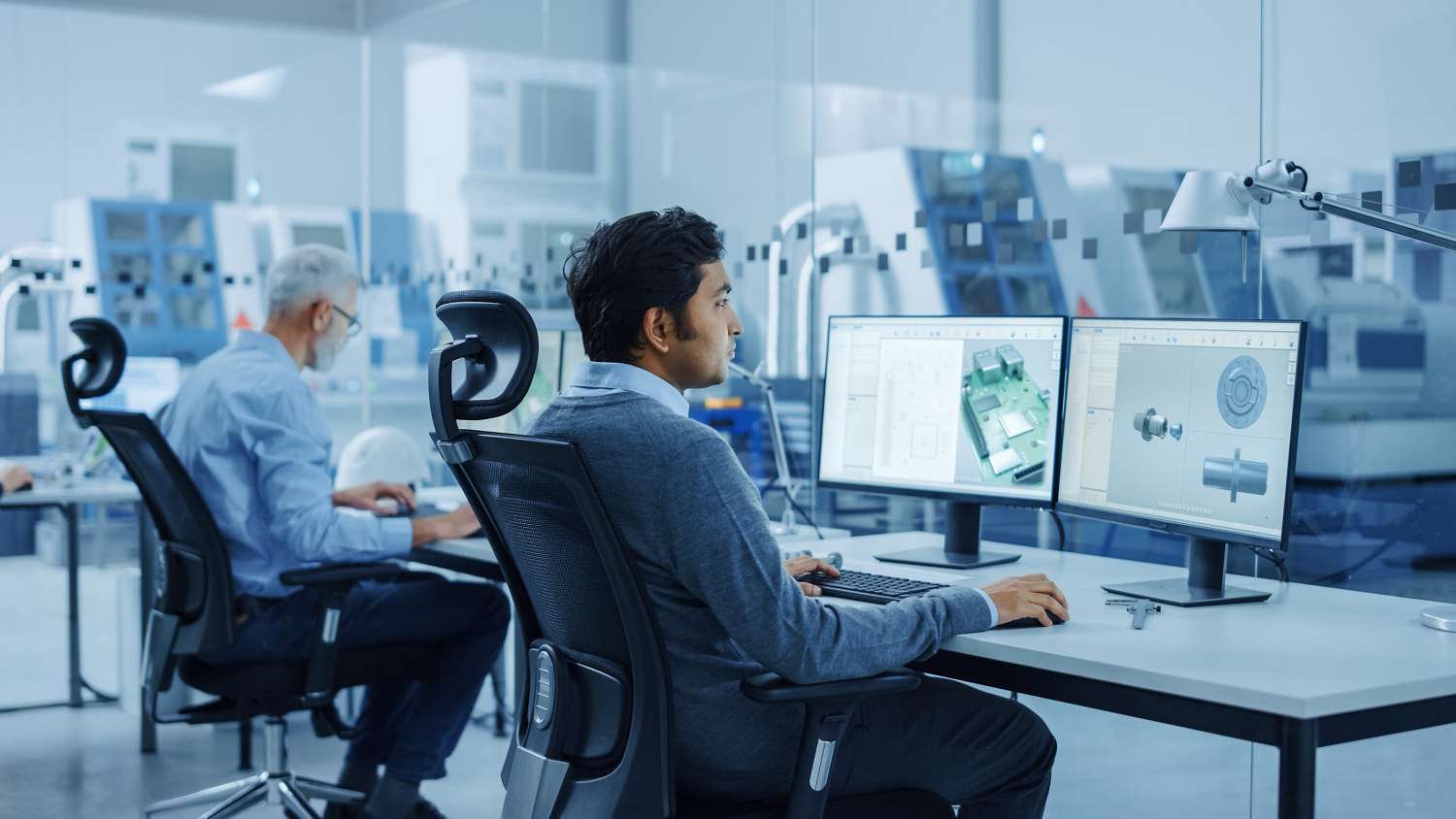 men on computers in clean workshop